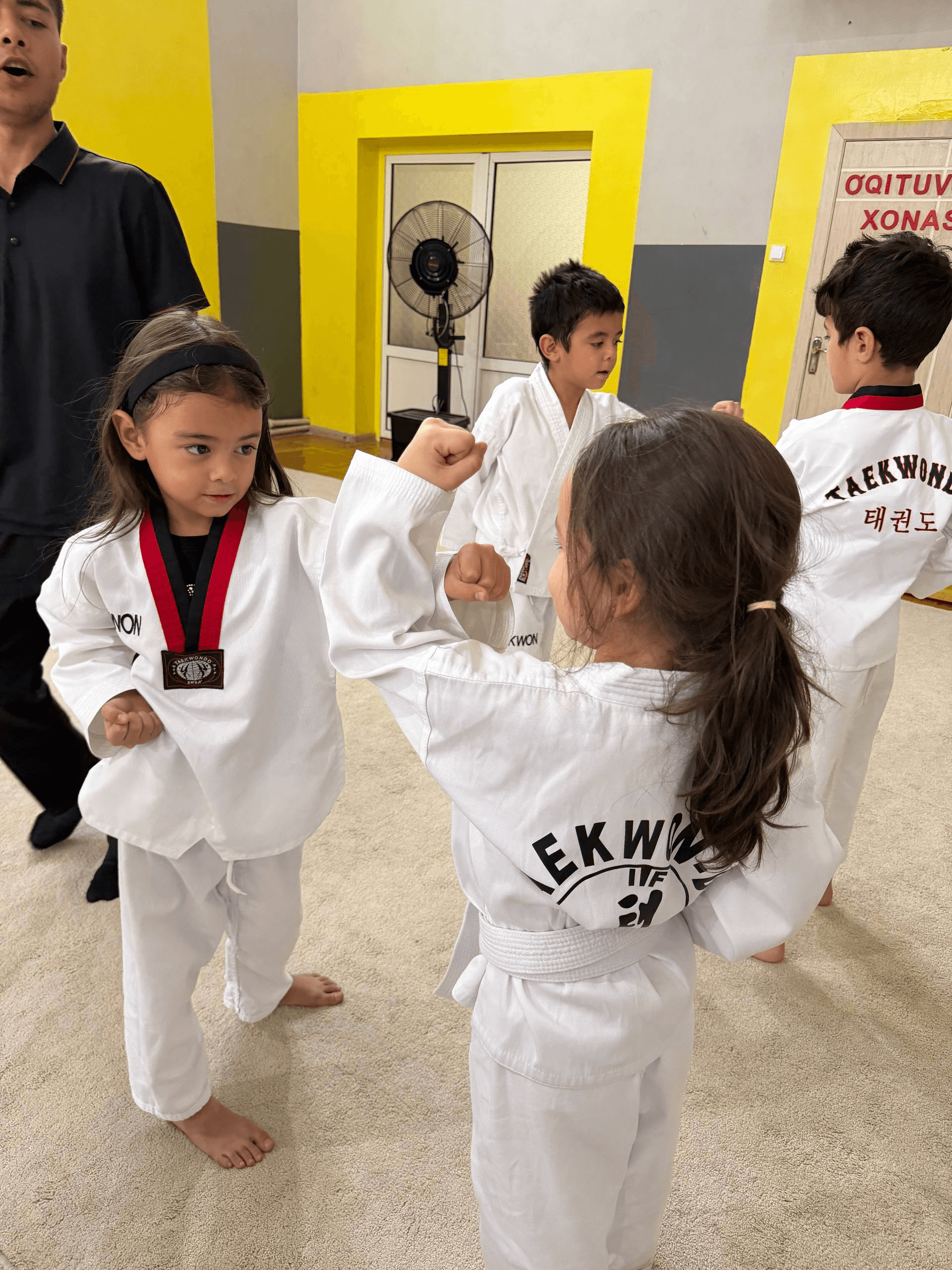 Children practicing taekwondo in uniform at Little Britain Daycare